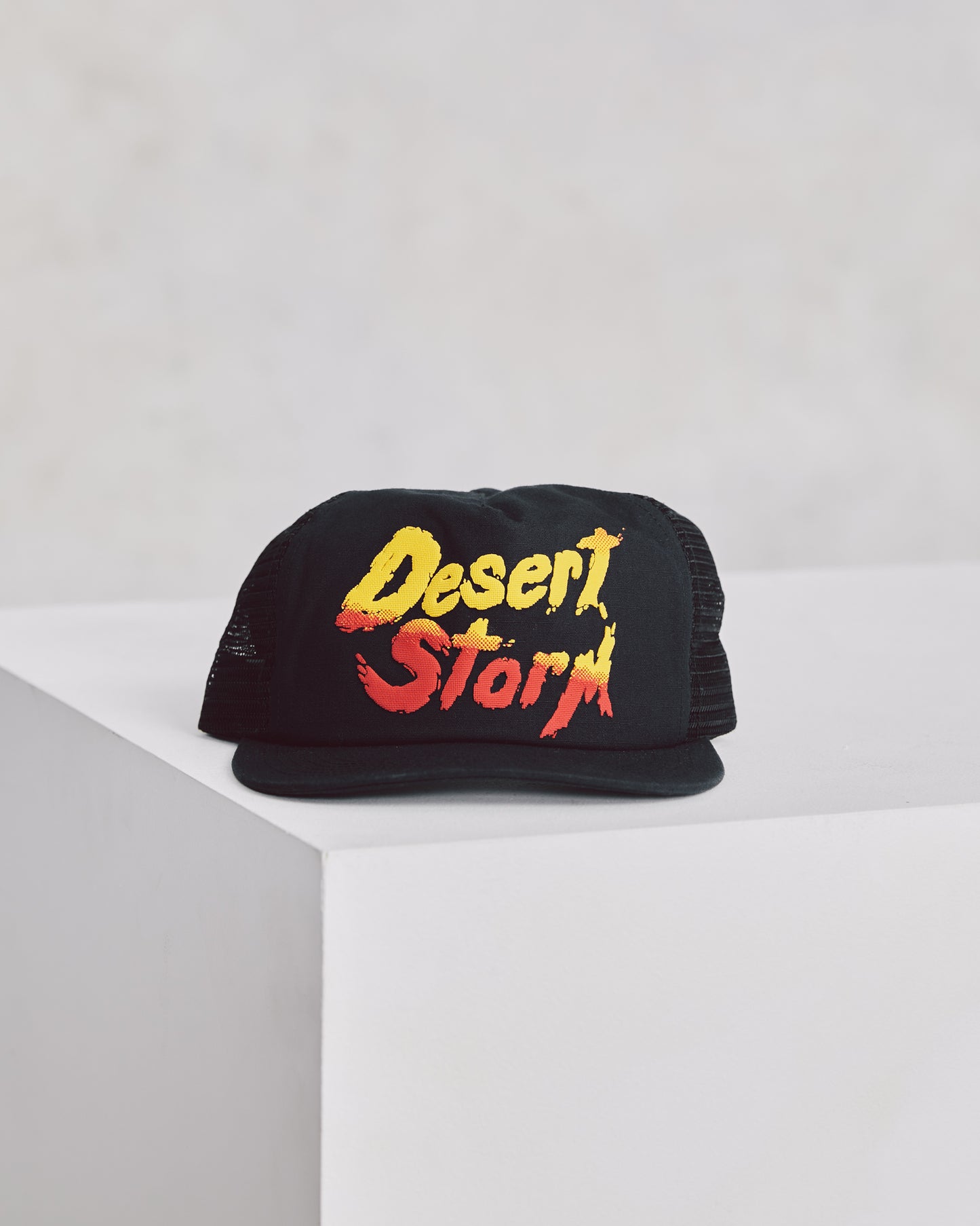 Black Supreme Trucker Hat with Red and Yellow Desert Storm Graphic